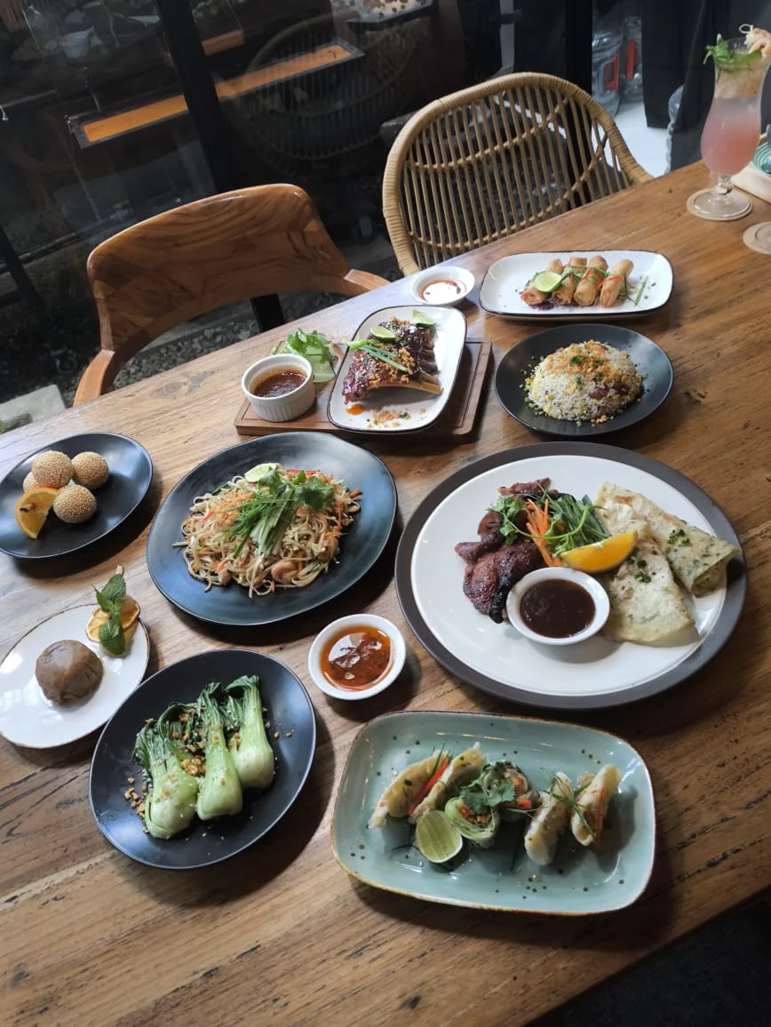 An overhead spread of dishes laid across a wooden table